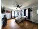 Inviting living room with hardwood floors, a ceiling fan, and ample natural light at 3949 Fletcher Ave, Indianapolis, IN 46203