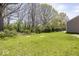 A backyard featuring lush green grass and mature trees at 4363 Rhapsody Ln, Indianapolis, IN 46235