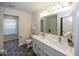 Bathroom with double sink vanity, large mirror, and shower/tub combo at 4363 Rhapsody Ln, Indianapolis, IN 46235