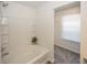 Clean bathroom features white tub, white tile, and shower head at 4363 Rhapsody Ln, Indianapolis, IN 46235