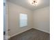 Simple bedroom featuring modern light fixture, plank flooring, and a bright window at 4363 Rhapsody Ln, Indianapolis, IN 46235