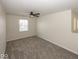 Bedroom with neutral paint, ceiling fan, plush gray carpet, and natural light at 4363 Rhapsody Ln, Indianapolis, IN 46235