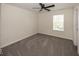 Cozy bedroom featuring neutral walls, carpet flooring, window, and a ceiling fan at 4363 Rhapsody Ln, Indianapolis, IN 46235