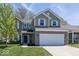 Inviting two-story home with a brick and siding exterior, complemented by a well-maintained lawn at 4363 Rhapsody Ln, Indianapolis, IN 46235