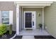 Charming front porch featuring a stylish black door and attractive landscaping at 4363 Rhapsody Ln, Indianapolis, IN 46235