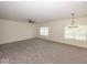 Expansive living room with neutral carpet, ceiling fan, and chandelier at 4363 Rhapsody Ln, Indianapolis, IN 46235