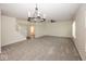Spacious living room featuring neutral carpet and an elegant chandelier at 4363 Rhapsody Ln, Indianapolis, IN 46235