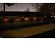 A fenced backyard is illuminated by string lights, creating a cozy outdoor space for evening enjoyment at 445 W 86Th St, Indianapolis, IN 46260