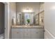 Well-lit bathroom features a double vanity with granite countertops and contemporary fixtures at 445 W 86Th St, Indianapolis, IN 46260