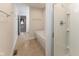 Bathroom with a modern tub and glass-enclosed shower and hooks for hanging towels at 445 W 86Th St, Indianapolis, IN 46260