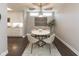 Bright dining area with modern lighting, neutral paint, and view into the kitchen at 445 W 86Th St, Indianapolis, IN 46260