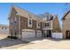 Stunning multi-story home featuring a 3-car garage, brick and stone accents, and a well-manicured front yard at 445 W 86Th St, Indianapolis, IN 46260