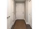 Hallway featuring doors and a woven rug. Flooring is hardwood at 445 W 86Th St, Indianapolis, IN 46260