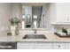 Granite countertops and a stainless steel sink are the focal point in this home's kitchen at 445 W 86Th St, Indianapolis, IN 46260