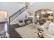 Inviting living room with dark wood floors, staircase and archway to the kitchen and dining room at 445 W 86Th St, Indianapolis, IN 46260
