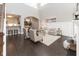 Open-concept living room with hardwood floors, stylish furniture, and seamless access to the kitchen and dining area at 445 W 86Th St, Indianapolis, IN 46260