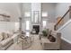 Bright living room featuring a cozy fireplace, high ceilings, hardwood floors and stylish furniture for relaxing and entertaining at 445 W 86Th St, Indianapolis, IN 46260