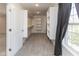 Bright walk-in closet with adjustable shelving, grey carpet, and natural light from a window at 445 W 86Th St, Indianapolis, IN 46260