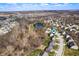 Panoramic aerial view of a residential neighborhood featuring winding streets, a pond, and well-spaced homes at 4846 Shakamak Ct, Indianapolis, IN 46239