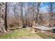Secluded backyard featuring a hammock and fire pit surrounded by mature trees at 4846 Shakamak Ct, Indianapolis, IN 46239