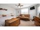 Comfortable bedroom boasts natural light, ceiling fan, wood chest, and decorative touches at 4846 Shakamak Ct, Indianapolis, IN 46239