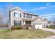 Charming two-story home featuring vinyl siding, black shutters, and an attached two-car garage at 4846 Shakamak Ct, Indianapolis, IN 46239
