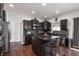 Stylish kitchen features dark cabinets, stainless steel appliances, granite countertops, and a central island with bar seating at 4846 Shakamak Ct, Indianapolis, IN 46239