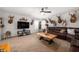 Spacious living room features a large TV, comfortable seating, and unique deer head wall decor at 4846 Shakamak Ct, Indianapolis, IN 46239