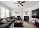 Living room with ample seating, fireplace, ceiling fan, and decorative wall art for a cozy, inviting space at 4846 Shakamak Ct, Indianapolis, IN 46239