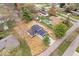 Aerial view of a house with a black roof, a long driveway and a spacious backyard at 4921 Cottonwood N Ct, Columbus, IN 47203