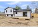 Rear view of the home featuring a new deck, sliding glass doors, and a spacious yard at 4921 Cottonwood N Ct, Columbus, IN 47203