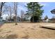 Spacious backyard featuring a wooden deck, mature trees, and a partially fenced yard at 4921 Cottonwood N Ct, Columbus, IN 47203
