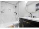Modern bathroom features tiled shower, floating shelves, and contemporary vanity with round mirror at 4921 Cottonwood N Ct, Columbus, IN 47203