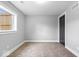 Bedroom featuring neutral walls, carpet flooring, white trim, closet and a window for natural light at 4921 Cottonwood N Ct, Columbus, IN 47203
