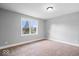 Bright bedroom features a neutral color palette, carpet, and a window offering natural light at 4921 Cottonwood N Ct, Columbus, IN 47203