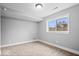 Neutral bedroom with carpet flooring, white trim, and a window offering natural light and an exterior view at 4921 Cottonwood N Ct, Columbus, IN 47203