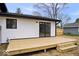 Close up showcasing a newly constructed wooden deck, contrasting with the white exterior at 4921 Cottonwood N Ct, Columbus, IN 47203