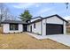 Charming home featuring modern black and white accents, attached garage, and well-manicured lawn at 4921 Cottonwood N Ct, Columbus, IN 47203