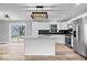 Modern kitchen with white cabinets, stainless steel appliances, island, and sliding glass door to backyard at 4921 Cottonwood N Ct, Columbus, IN 47203