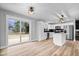 Bright open kitchen with stainless steel appliances, white cabinets, and a center island with countertop seating at 4921 Cottonwood N Ct, Columbus, IN 47203