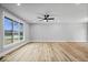 Spacious living room with wood floors, neutral walls, and large windows allowing for ample natural light at 4921 Cottonwood N Ct, Columbus, IN 47203