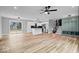 Spacious living room with kitchen, mudroom, modern lighting, and wood floors, creating a welcoming atmosphere at 4921 Cottonwood N Ct, Columbus, IN 47203