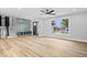 Bright living room with hardwood floors, mudroom, staircase, and a large window offering a view of the front yard at 4921 Cottonwood N Ct, Columbus, IN 47203