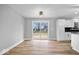 Bright living room with sliding doors and wood floors leading to an open-concept kitchen at 4921 Cottonwood N Ct, Columbus, IN 47203