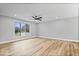 Large living room featuring wood floors, a ceiling fan, neutral walls, and a window with an exterior view at 4921 Cottonwood N Ct, Columbus, IN 47203