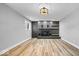 Stylish living room featuring a gray-brick fireplace with wooden accents and hardwood floors at 4921 Cottonwood N Ct, Columbus, IN 47203