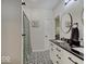 Modern bathroom with black and white tile flooring and granite counters, complemented by sleek fixtures and modern finishes at 501 W Pearl St, Trafalgar, IN 46181