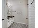 Modern bathroom showcasing granite countertops, and black and white patterned tile floors, creating a clean and fresh design at 501 W Pearl St, Trafalgar, IN 46181