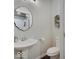 Chic half-bathroom featuring a modern pedestal sink and decorative mirror at 501 W Pearl St, Trafalgar, IN 46181