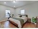 Cozy bedroom with hardwood floors, exercise bike, natural light, and rustic wooden bed frame at 501 W Pearl St, Trafalgar, IN 46181